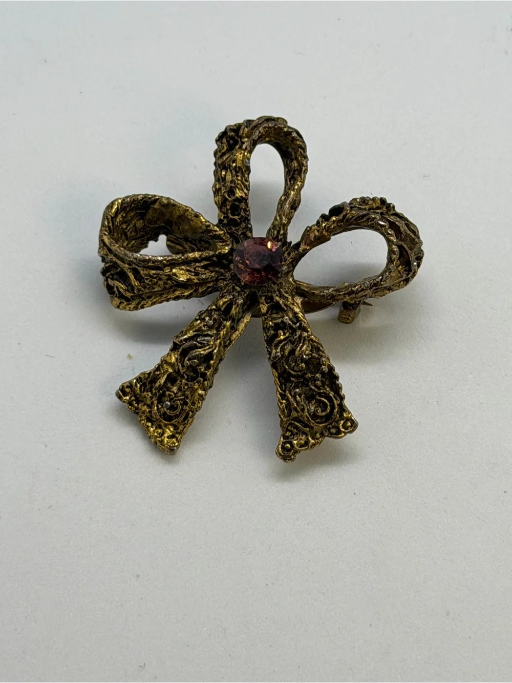 Gold-Tone Bow Brooch with Pink Center Stone